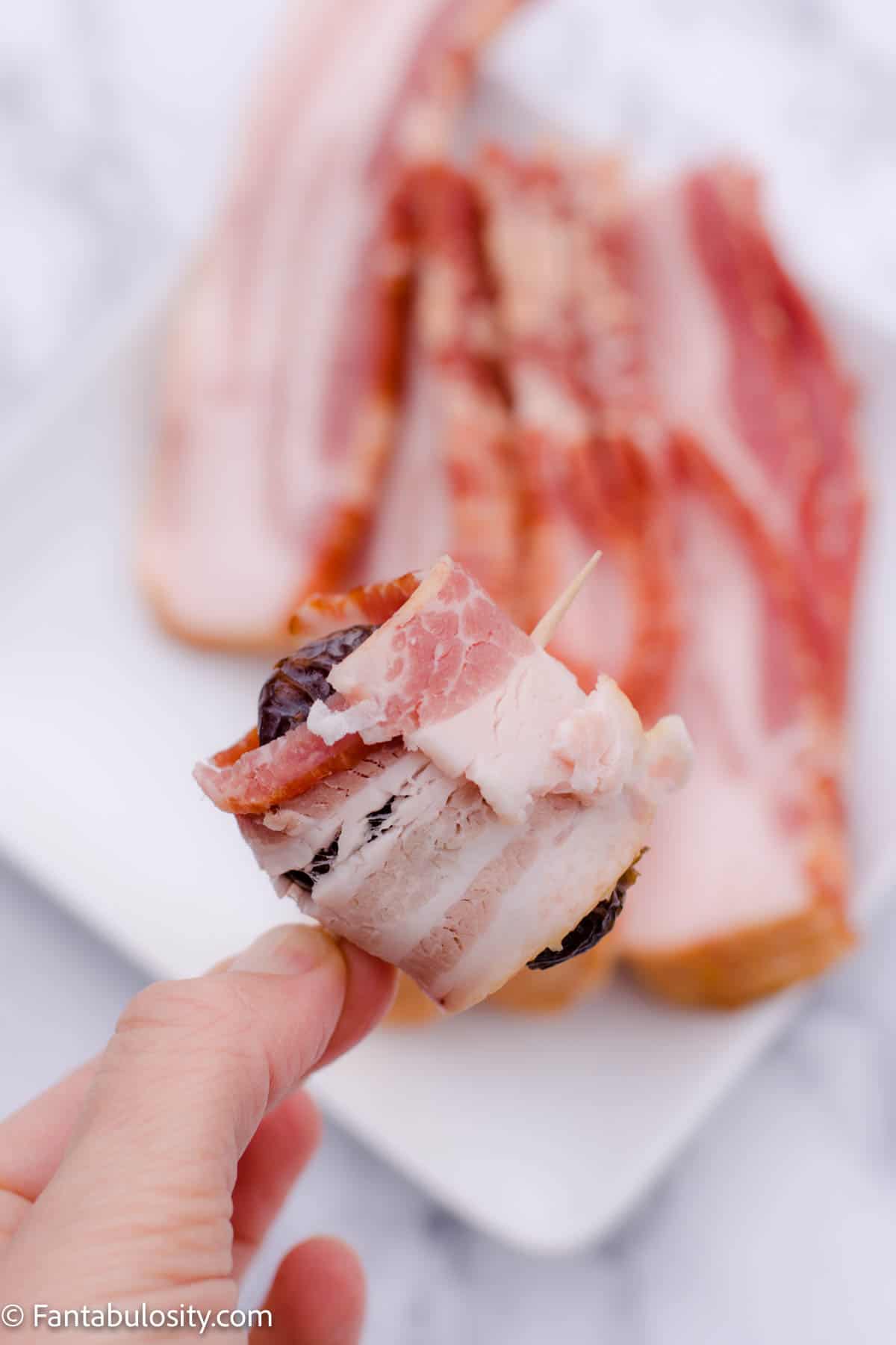 Wrap a half slice of bacon around your stuffed date and secure it with a toothpick.