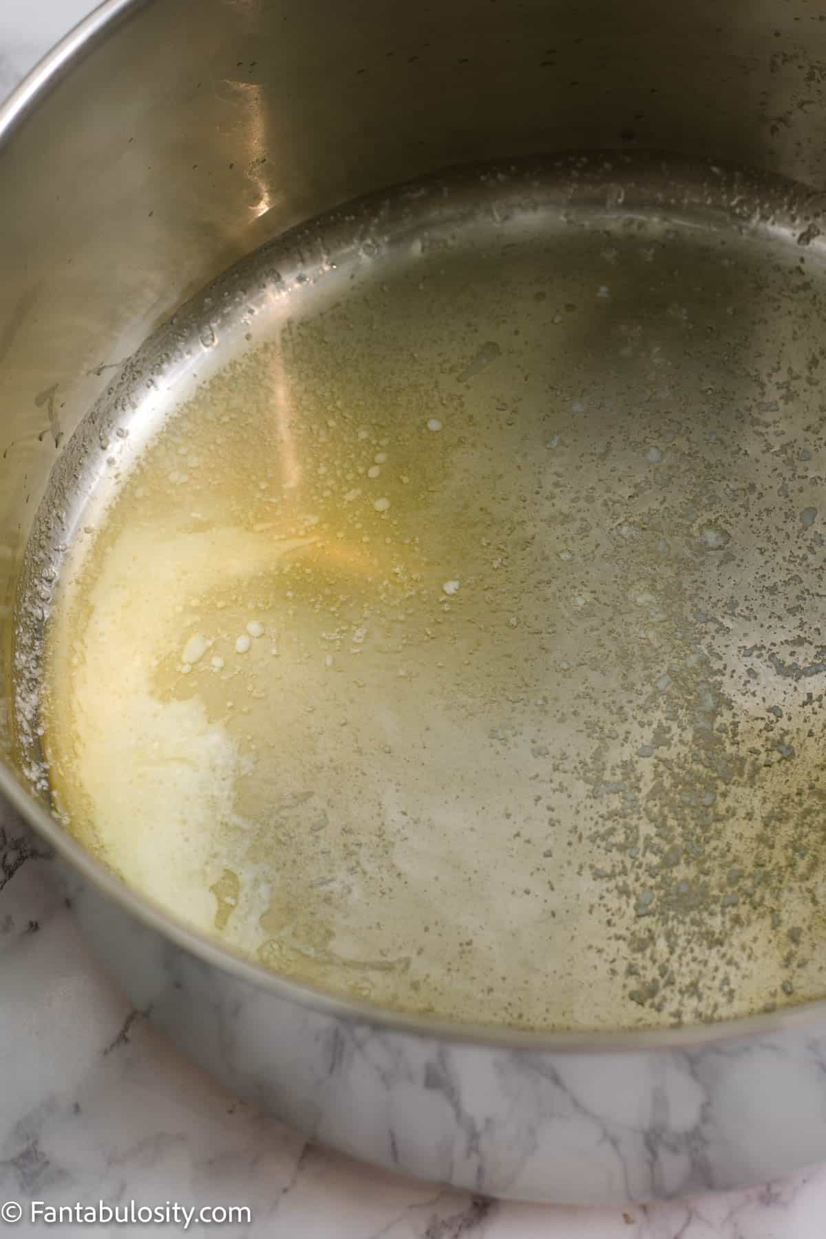 Melt the butter over low heat in a big stock pot.