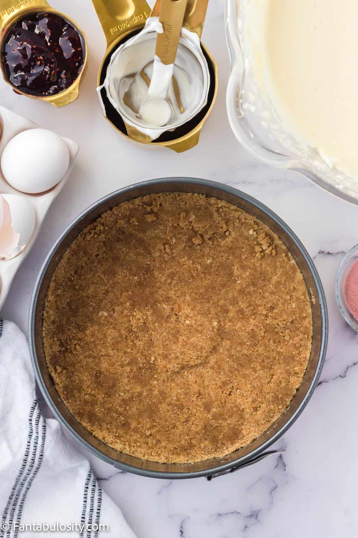 Press sandy crust mixture into the bottom of the springform pan.