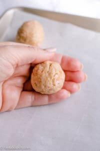 hands rolling small amount of truffle dough in to ball