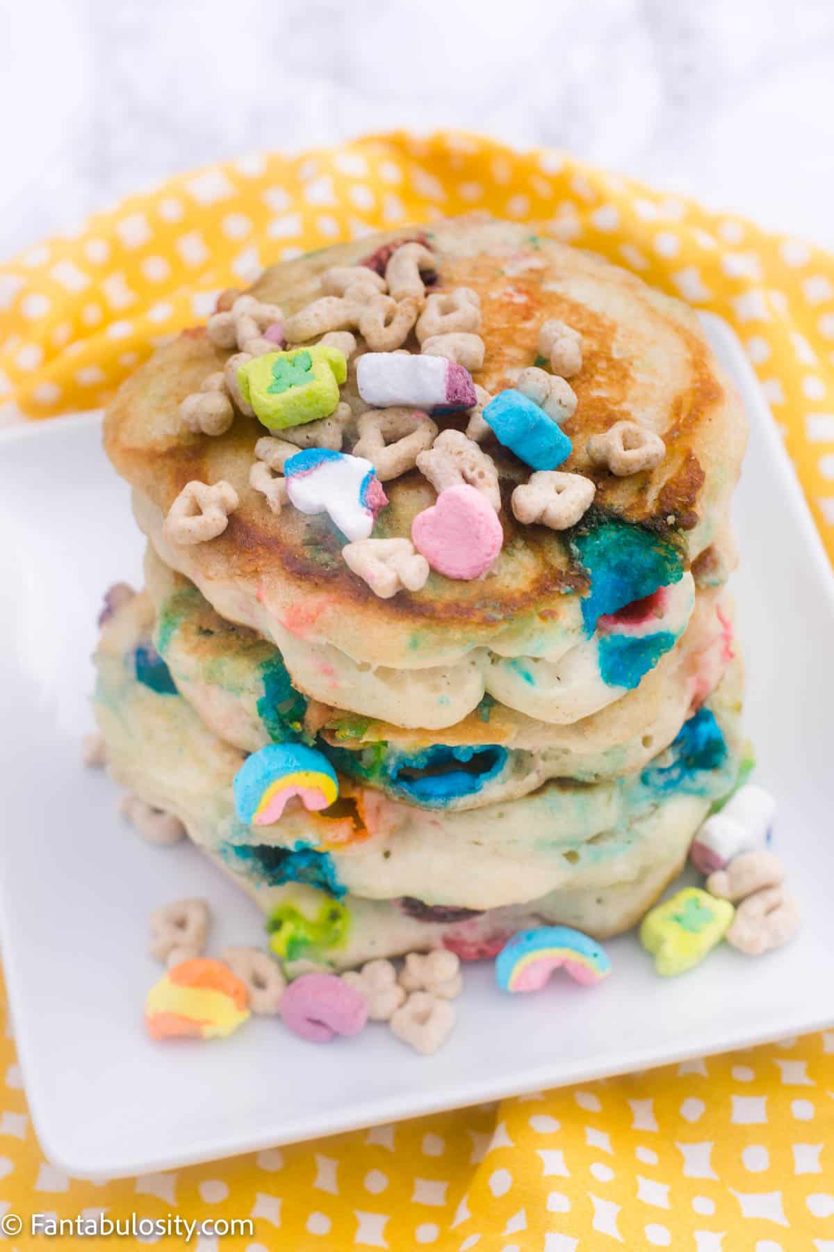 Stacked Lucky Charms Pancakes on white plate