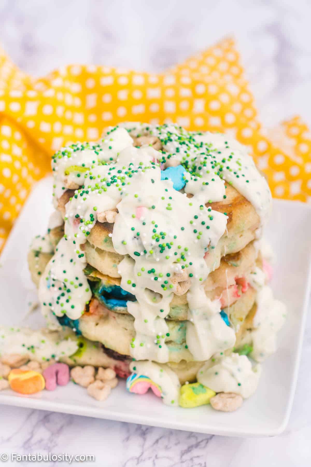 stacked lucky charms pancakes with chocolate syrup