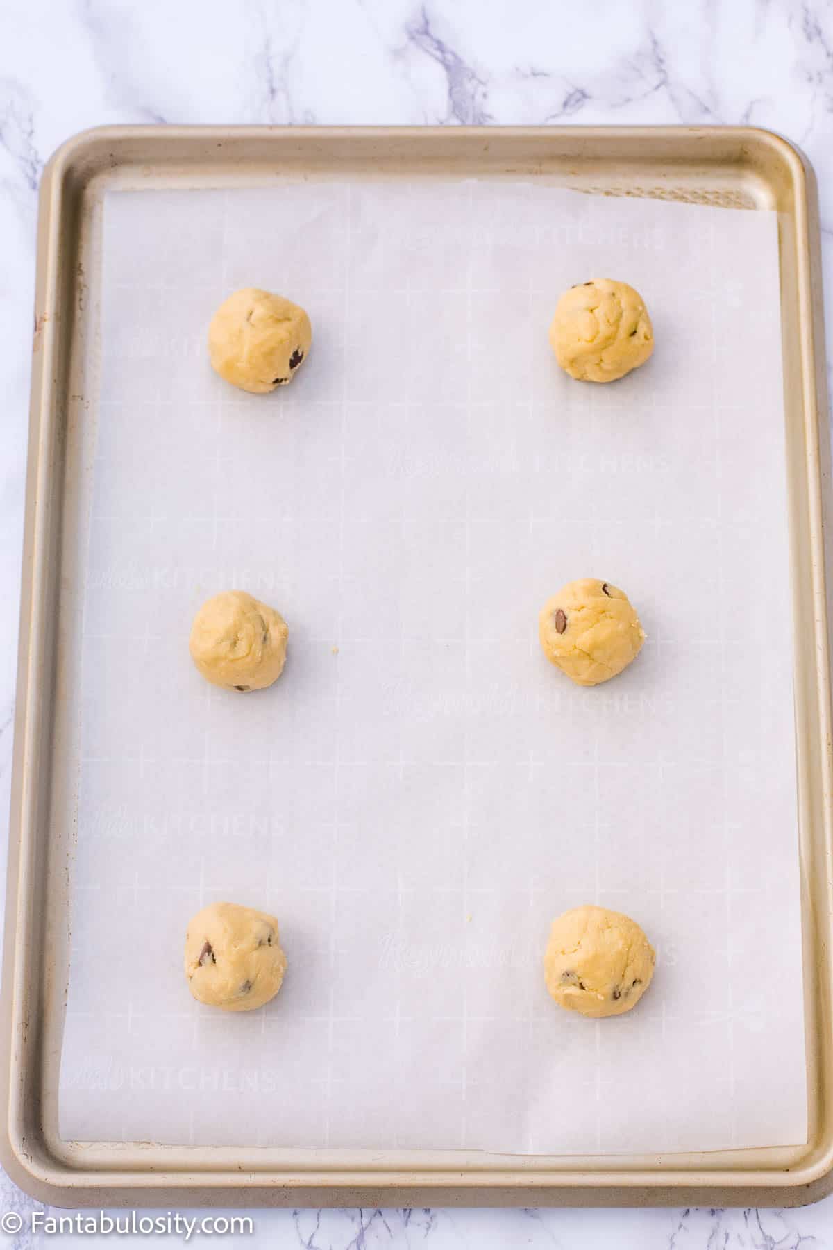 Chocolate chip cookie dough balls on baking sheet