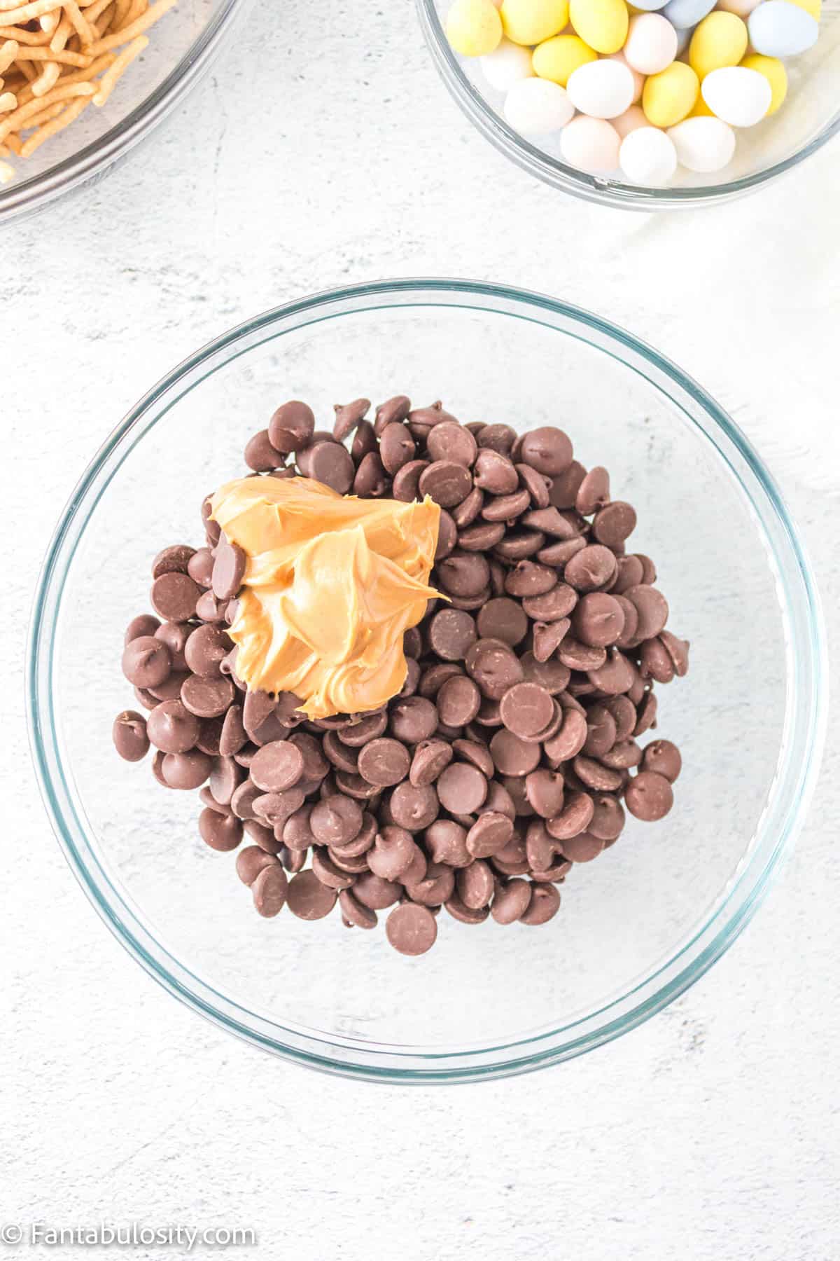 Chocolate chips and peanut butter in a microwave safe bowl. 