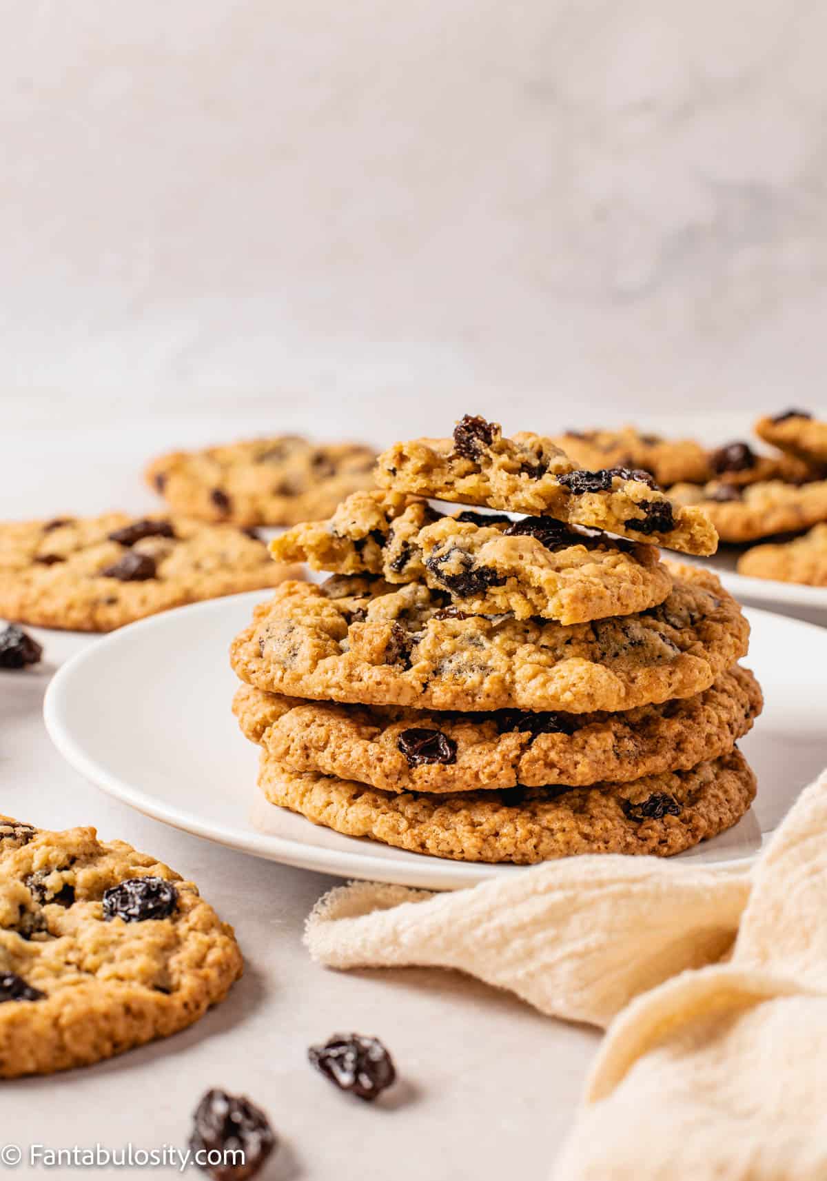 Oatmeal Raisin Cookies stacked on a plate.