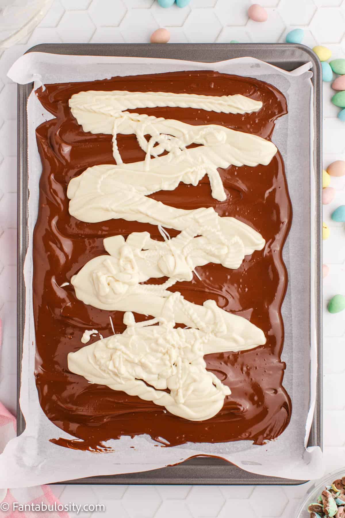 Melted white chocolate drizzled over the melted semi-sweet chocolate.