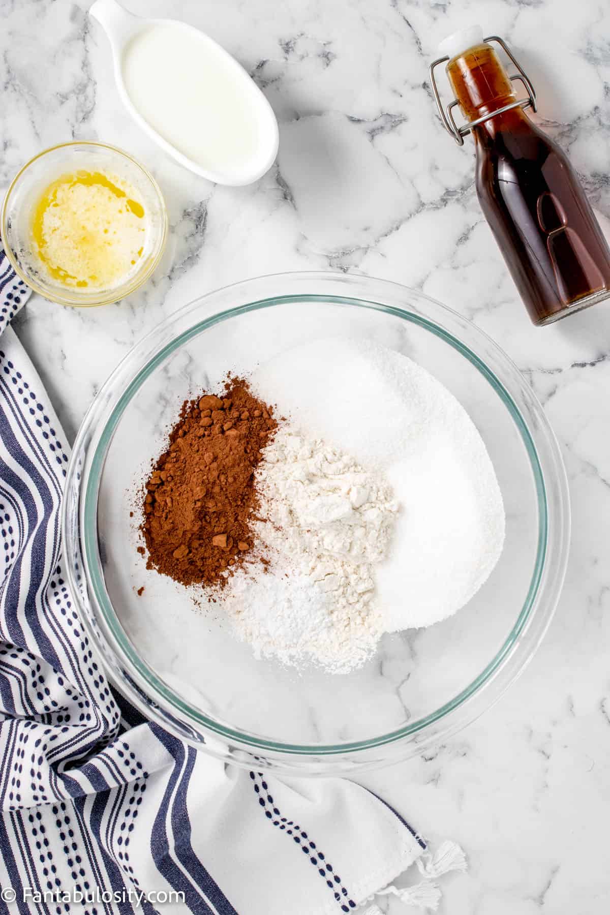 Flour, baking powder, salt, sugar, and cocoa in a glass bowl.