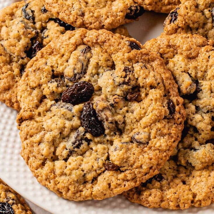 Close up image of one oatmeal cookie on a plate of cookies.