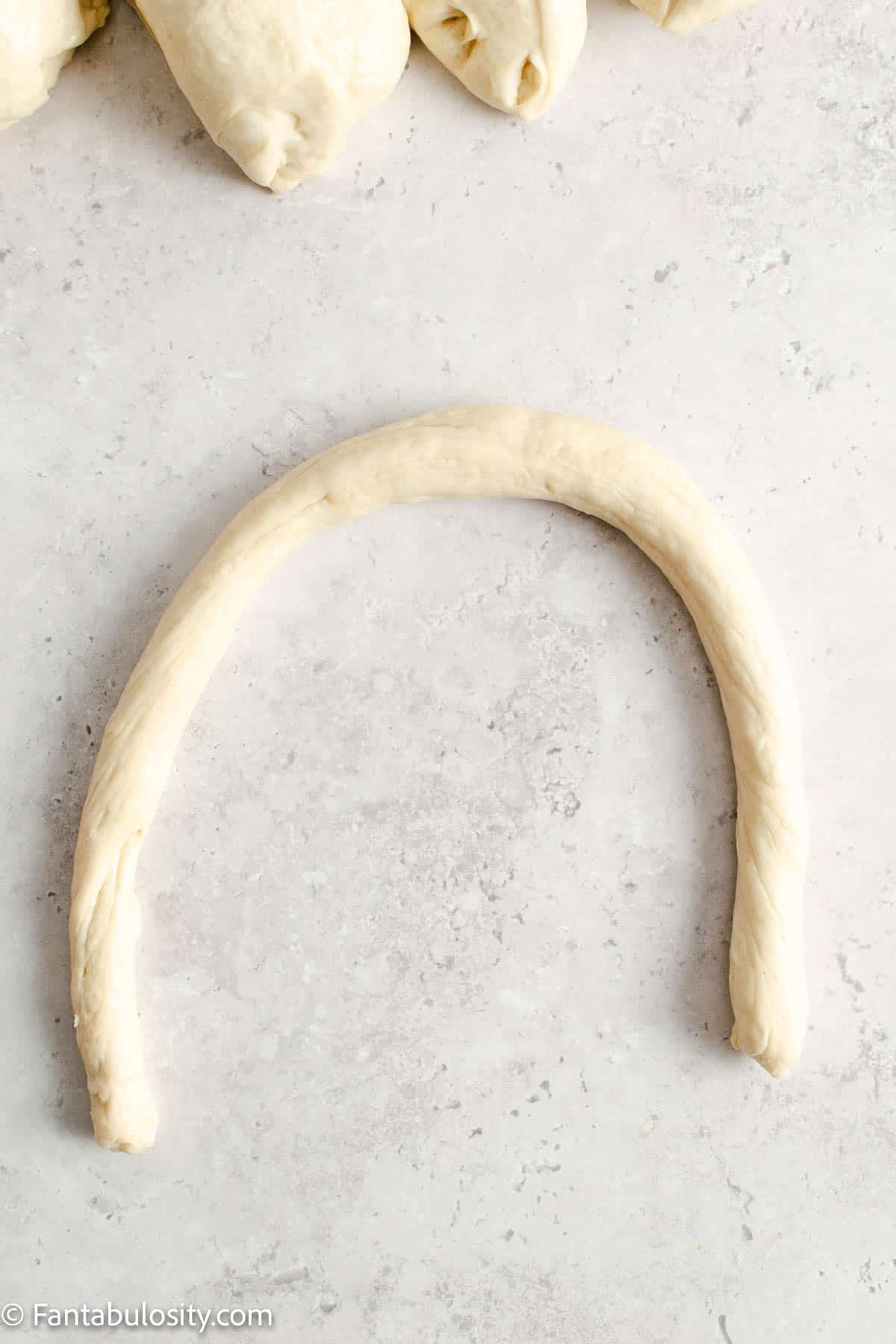Pretzel dough formed into a U shape. 