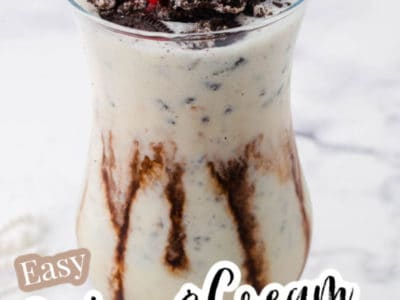 Cookies and cream milkshake in glass with cherry on top, and text on image