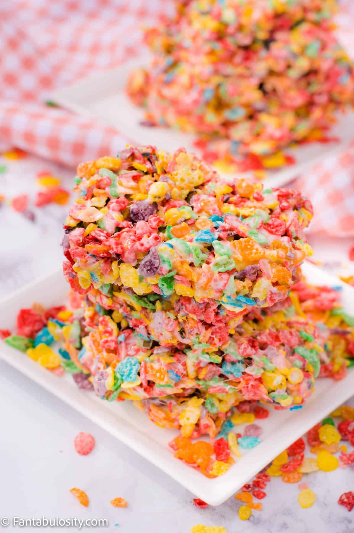 Fruity Pebbles Treats stacked on white plate