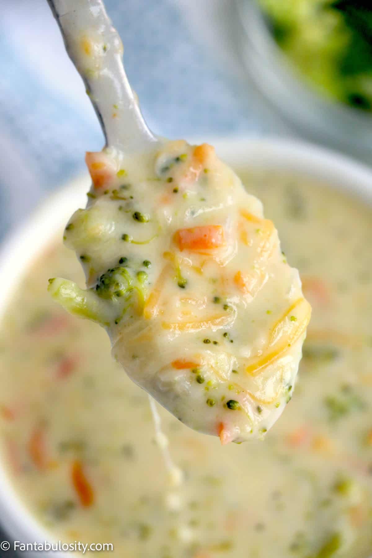 Close up of broccoli cheddar soup on spoon