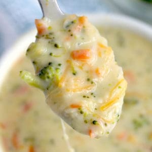Instant Pot Broccoli Cheddar Soup on spoon over bowl of soup