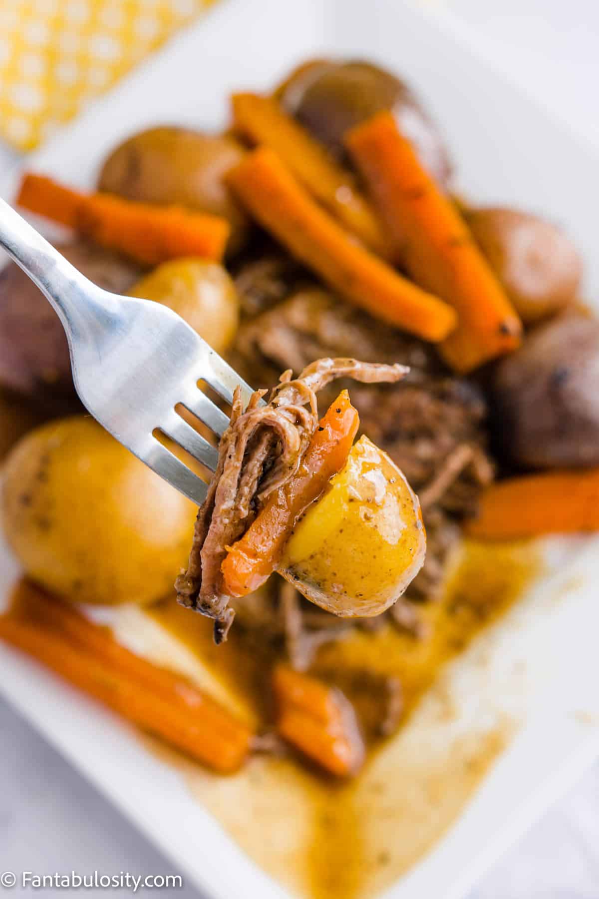 Tri tip roast with vegetables on fork