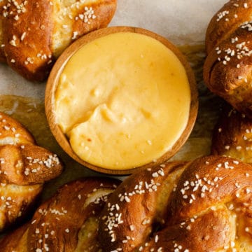Pretzel Cheese Dip surrounded by soft pretzels.