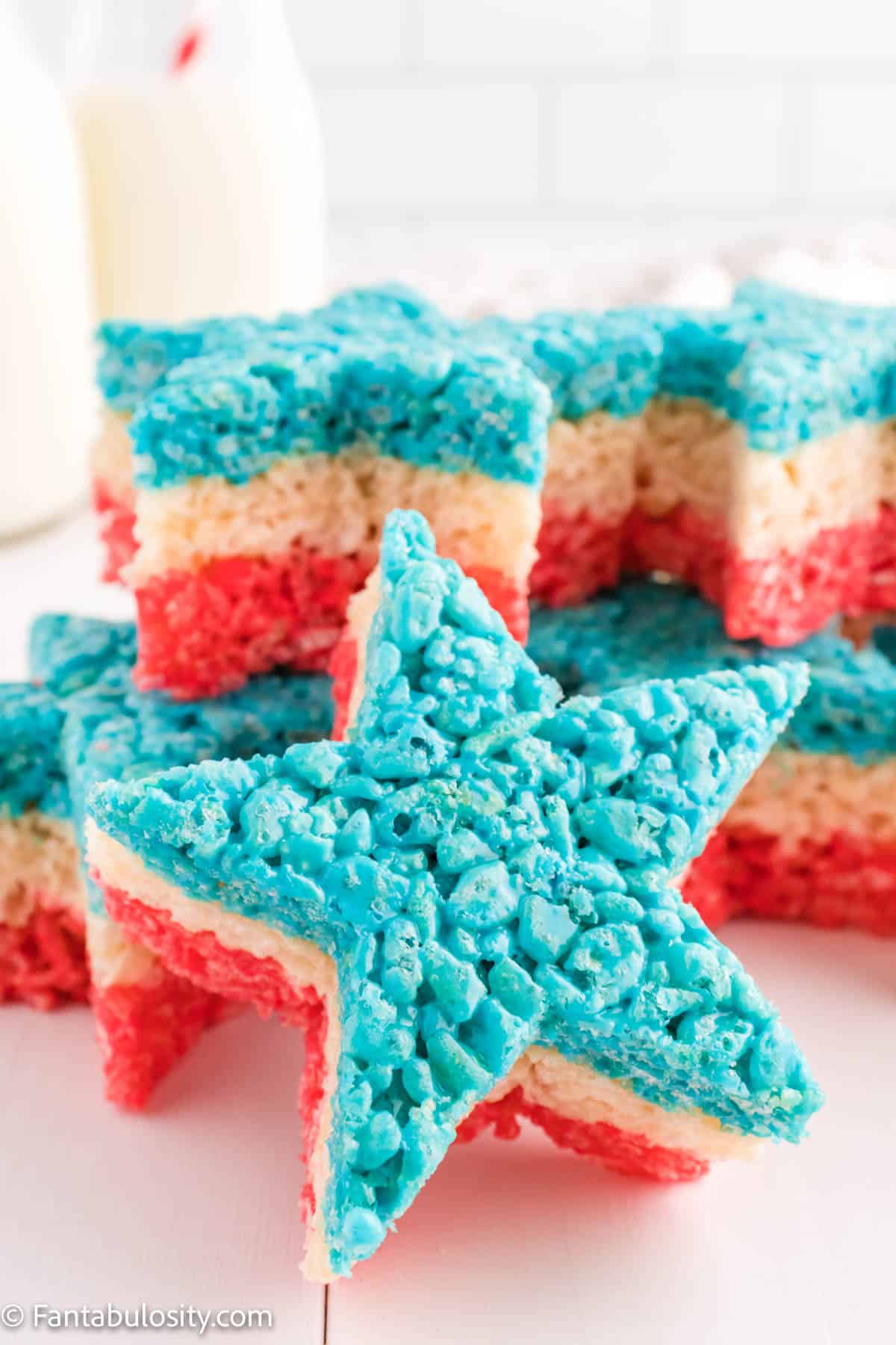 A stack of Rice Krispie treats shaped like stars that clearly show three layers - red, white, and blue.
