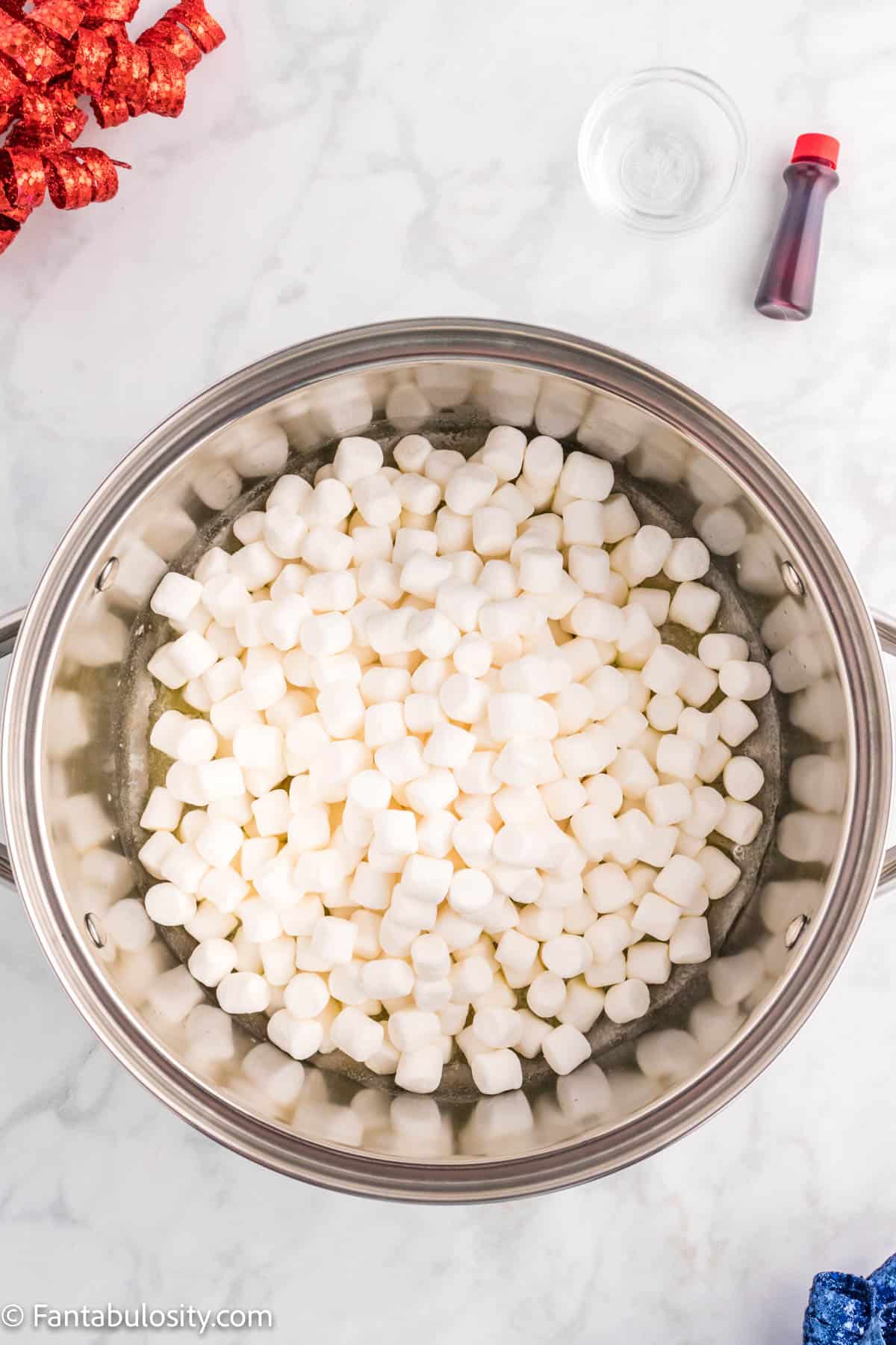 Marshmallows in a large pot with melted butter.