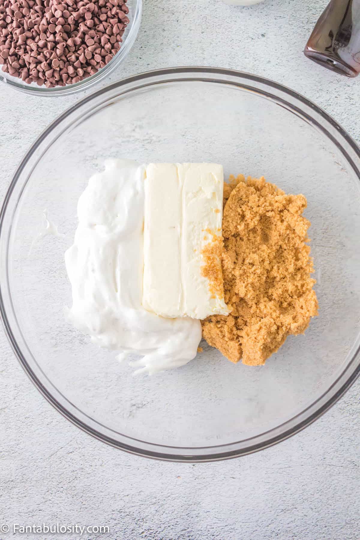 Brown sugar, cream cheese and marshmallow fluff in a glass bowl. 