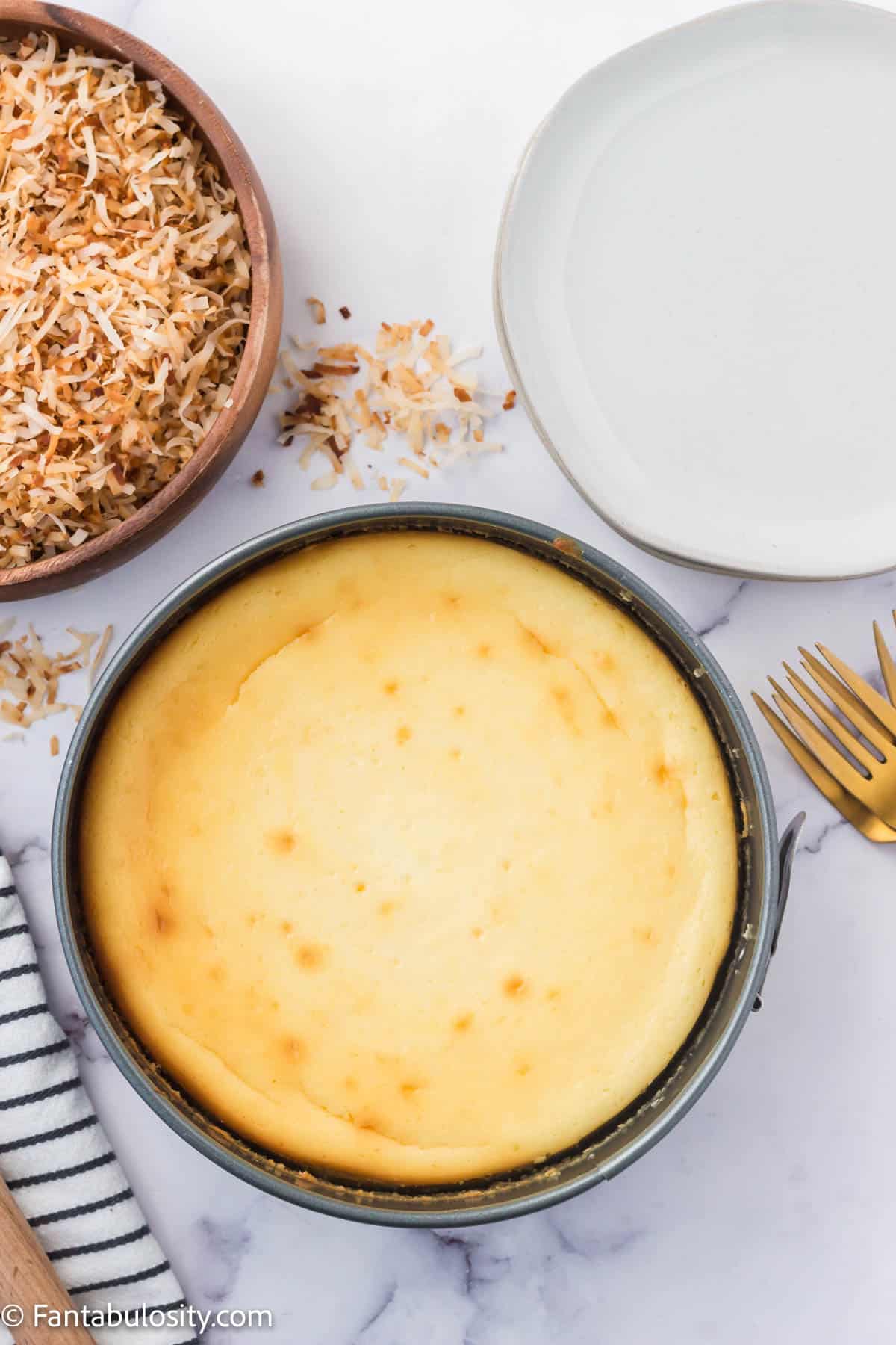 Baked coconut cheesecake in a springform pan.