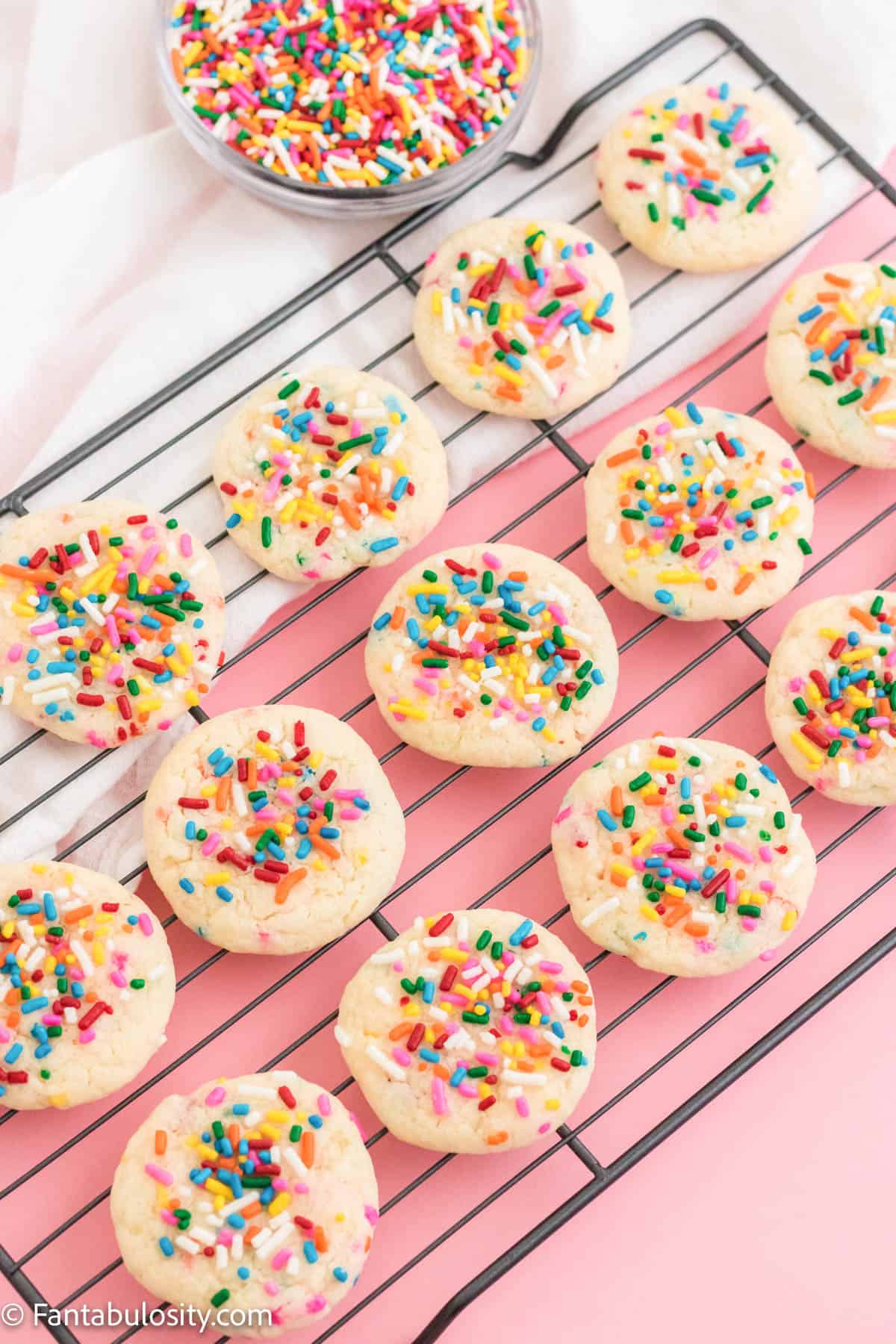 Funfetti cake mix cookies cooling on a wire rack.
