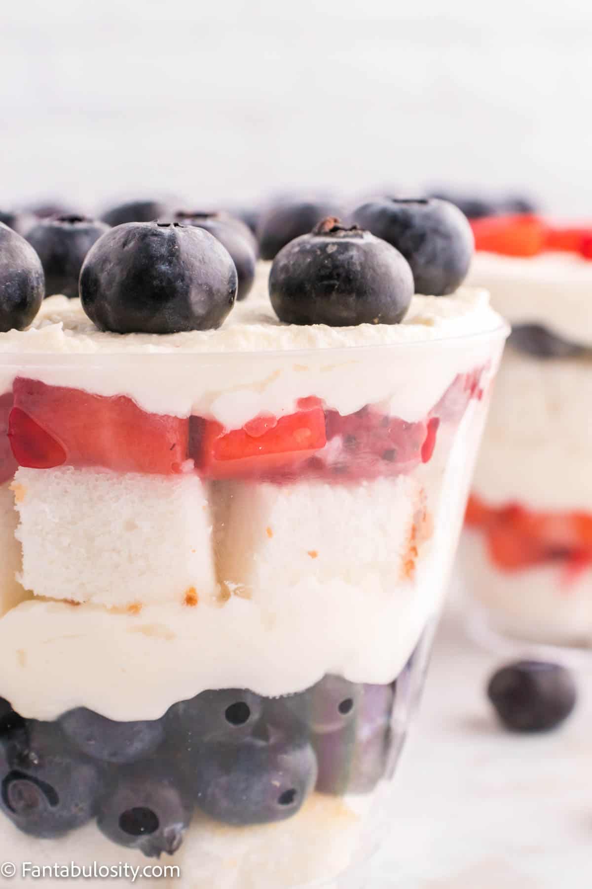 A close up photo of a mixed berry mini trifle. 