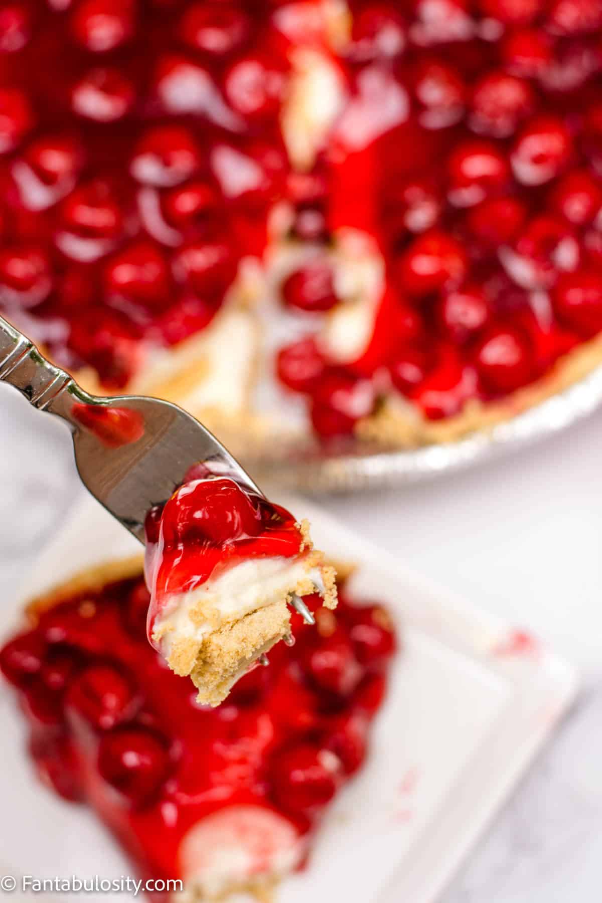 bite of cherry cheesecake on fork