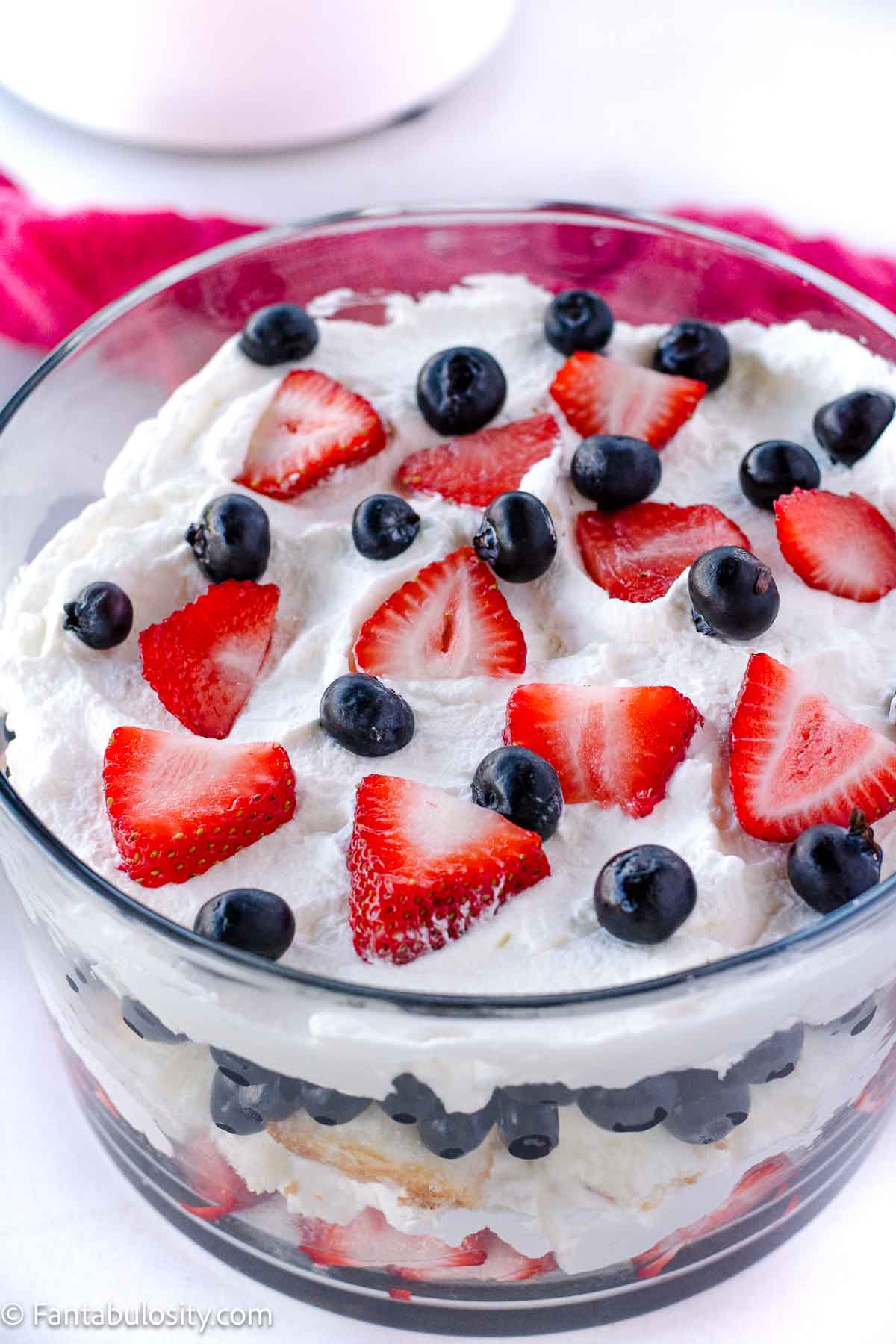 Strawberries and blueberries on top of angel food cake trifle.