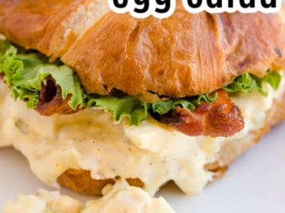 egg salad on a croissant with text on image