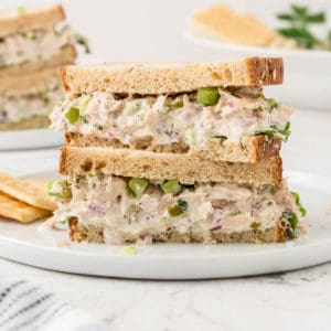 two tuna salad sandwiches stacked on top of one another