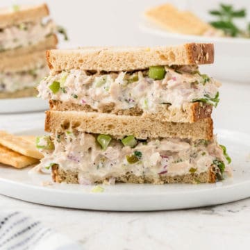 two tuna salad sandwiches stacked on top of one another