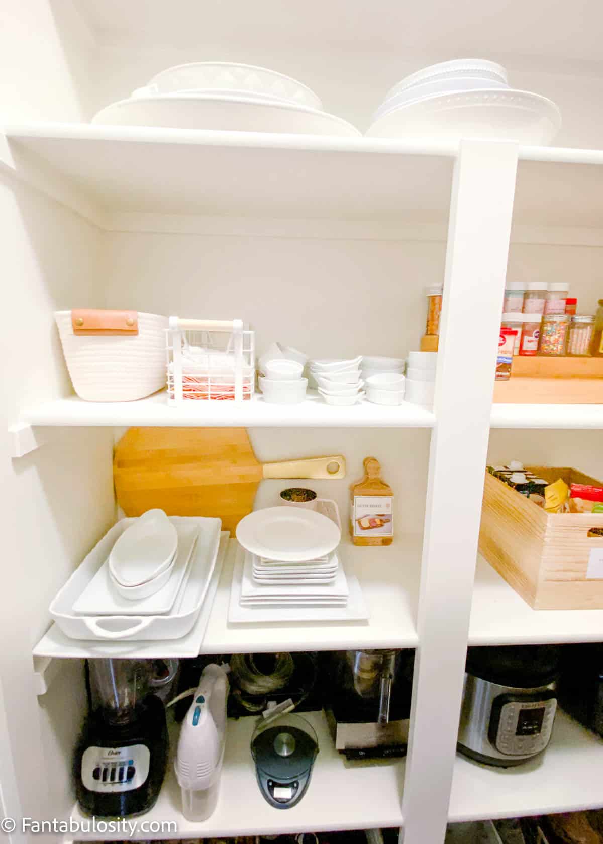 small appliances and white plates in pantry