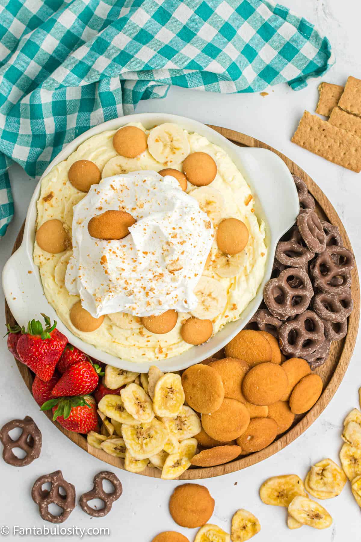 Banana Pudding Dip in bowl with dippers surrounding it on a tray