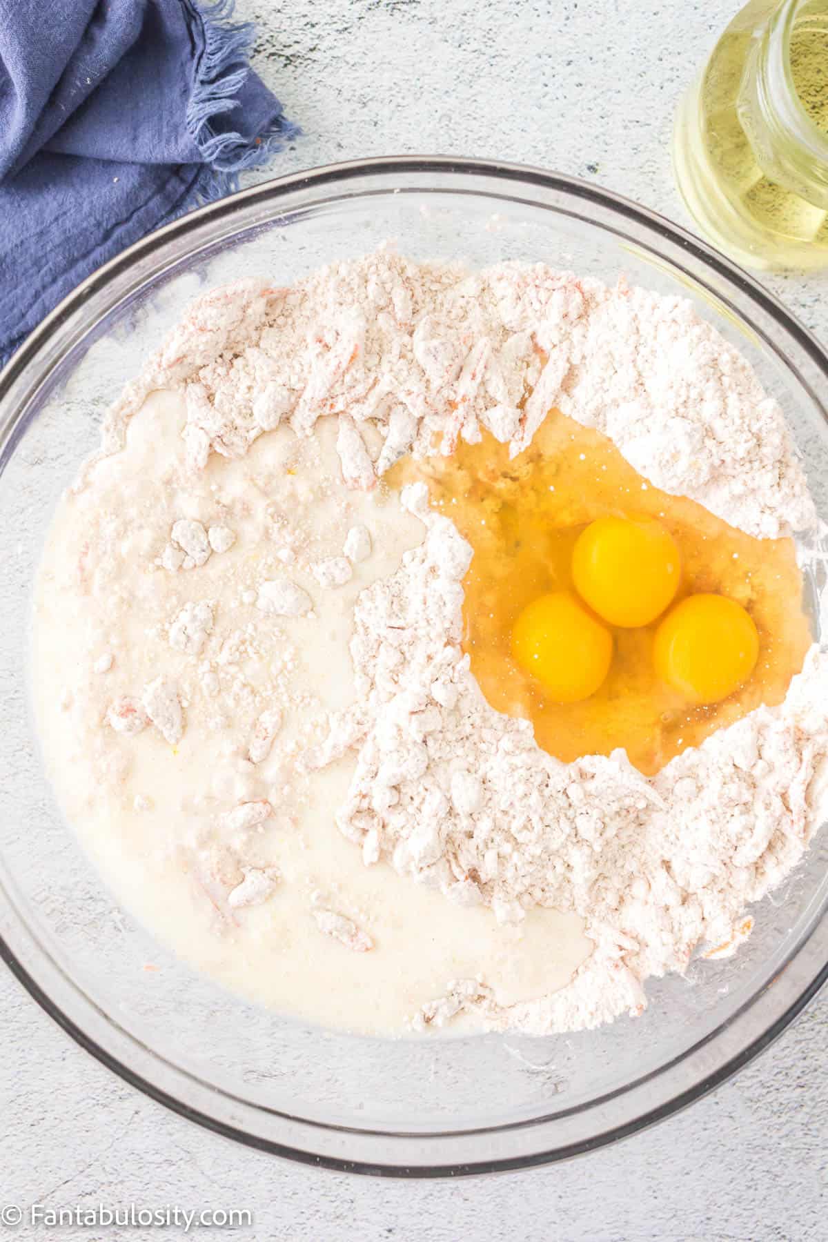 Milk, eggs, and dry ingredients in a bowl. 