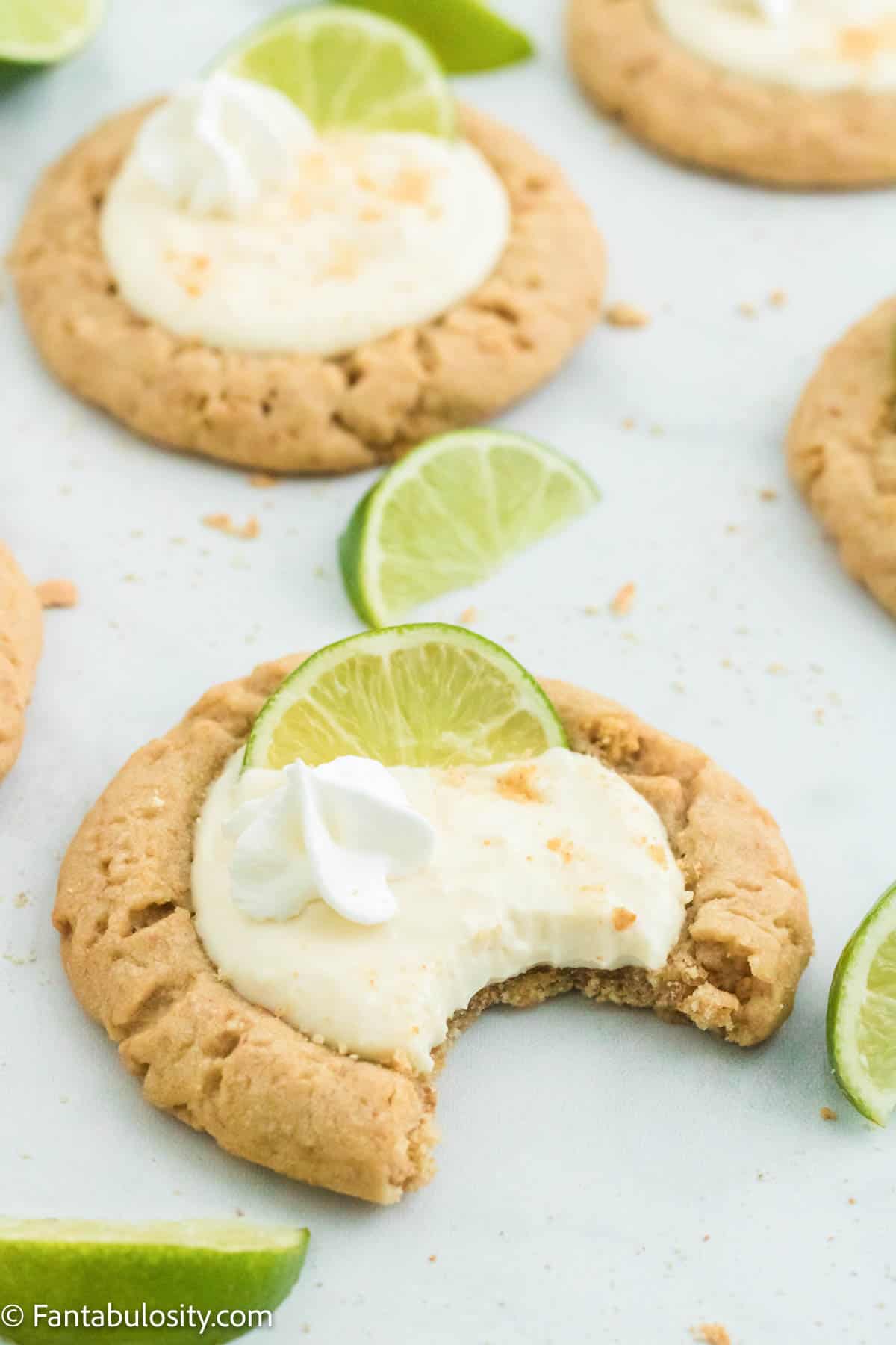 A key lime pie cookie with a bite out of it.
