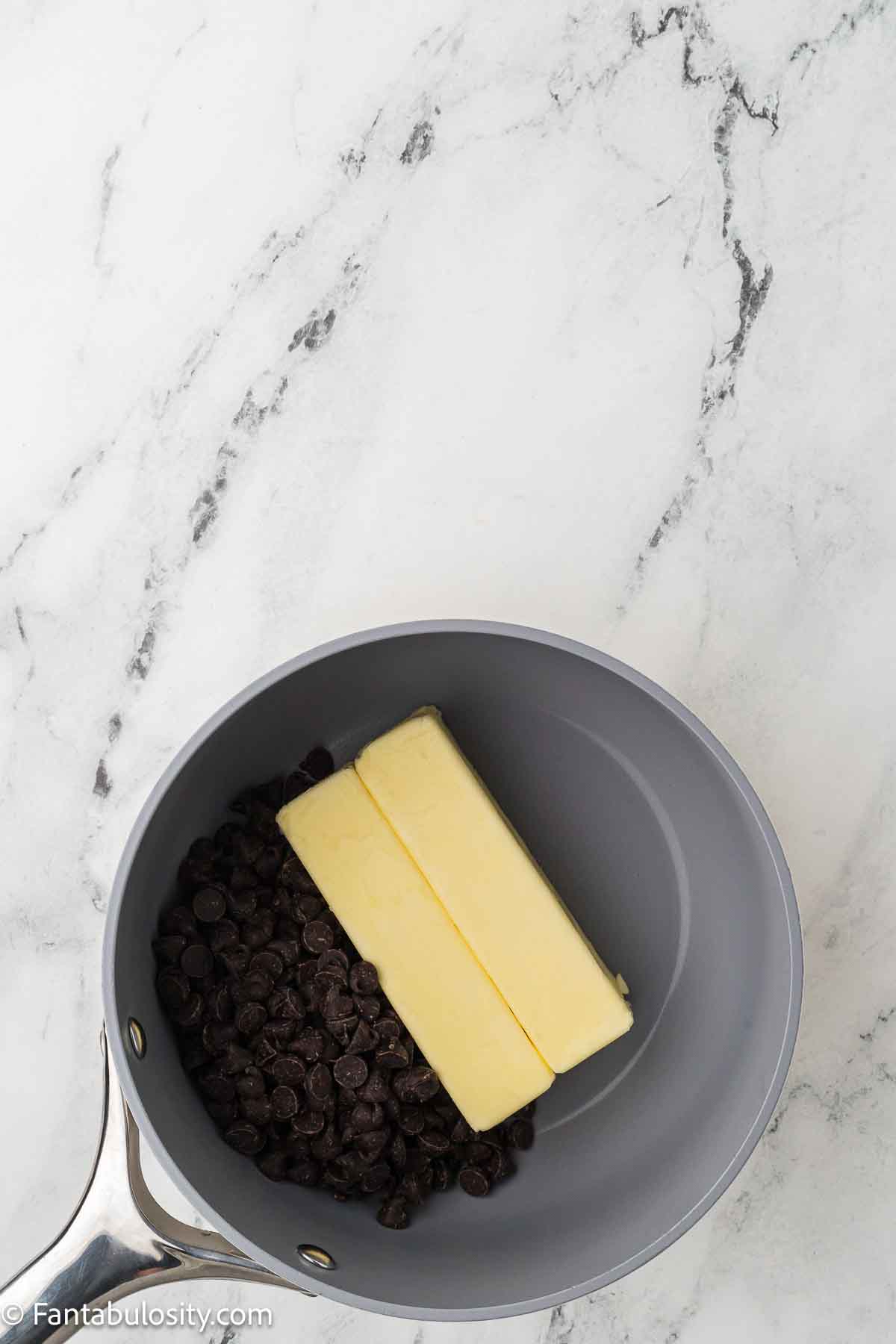 Chocolate chips and butter in sauce pan. 