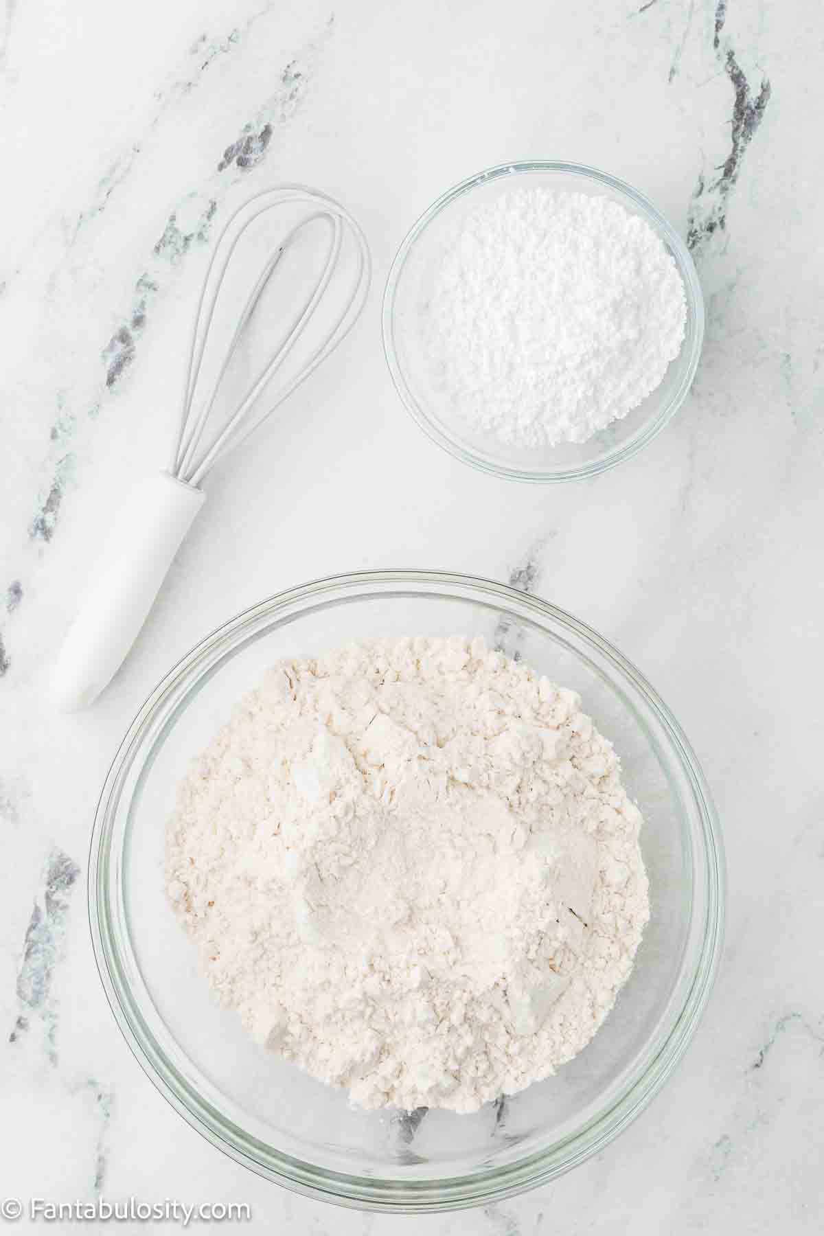 Flour and baking soda in mixing bowls.
