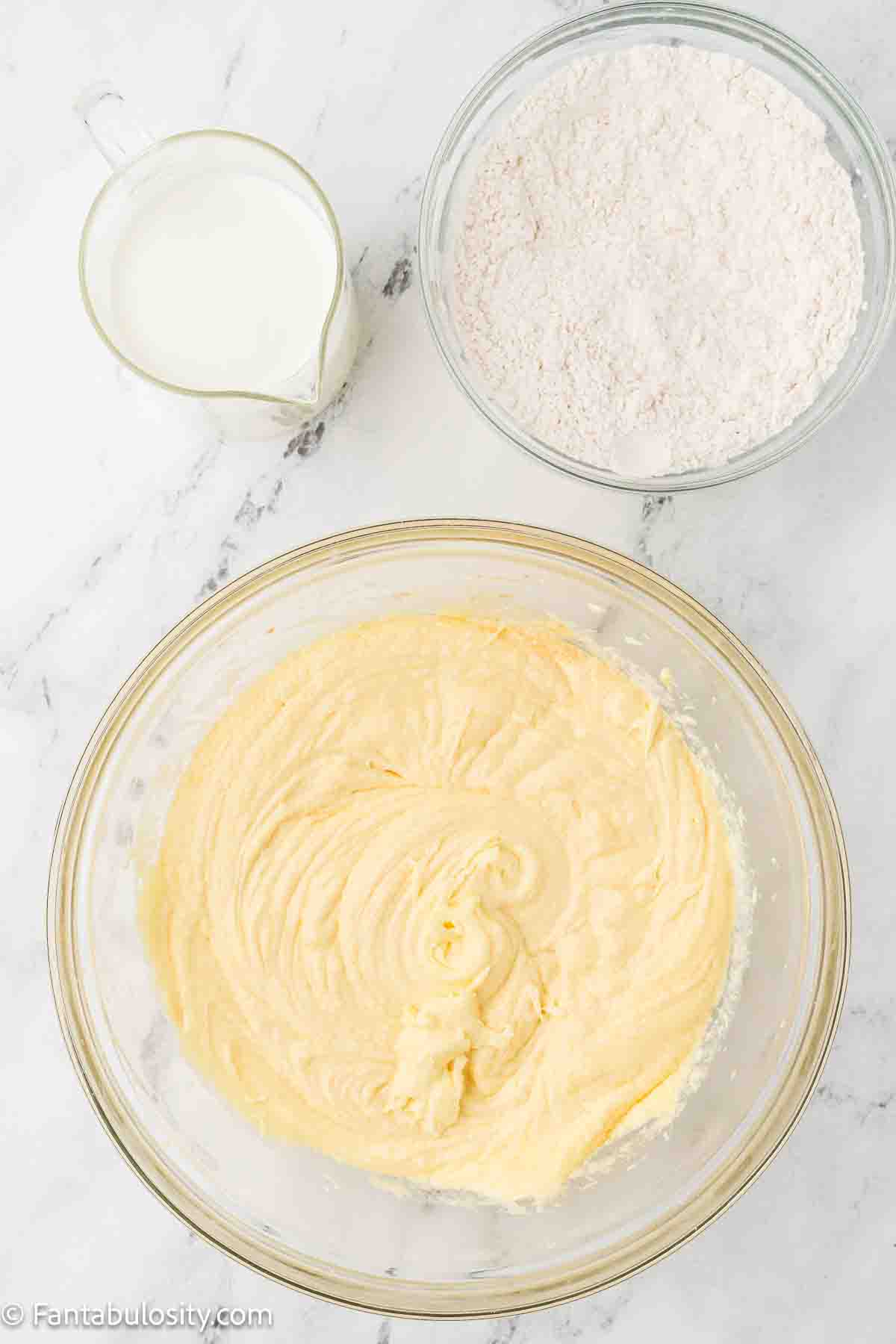 Flour and buttermilk sitting next to cake batter.