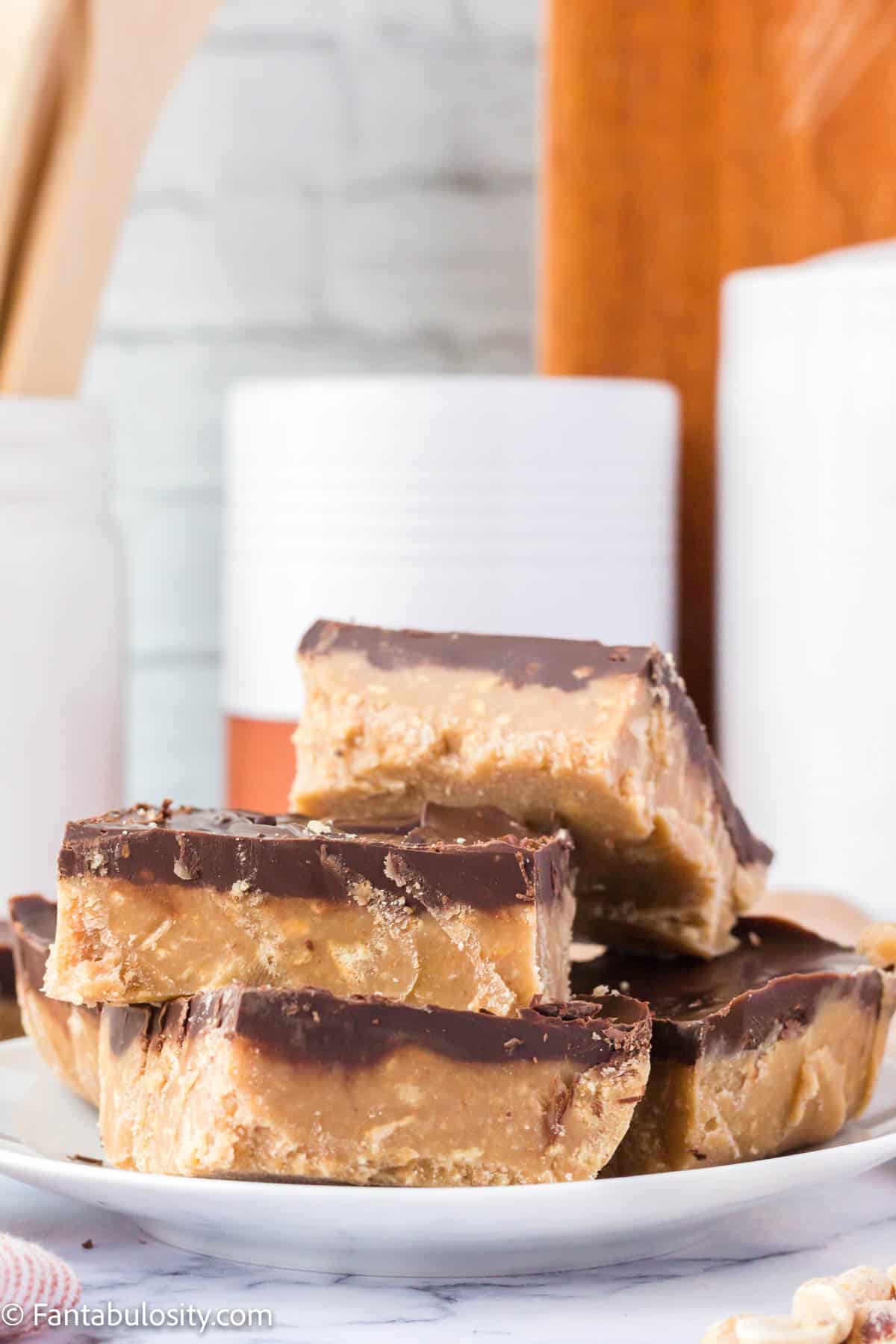 A stack of no bake chocolate peanut butter bars.