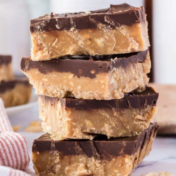 A stack of no bake chocolate peanut butter bars.