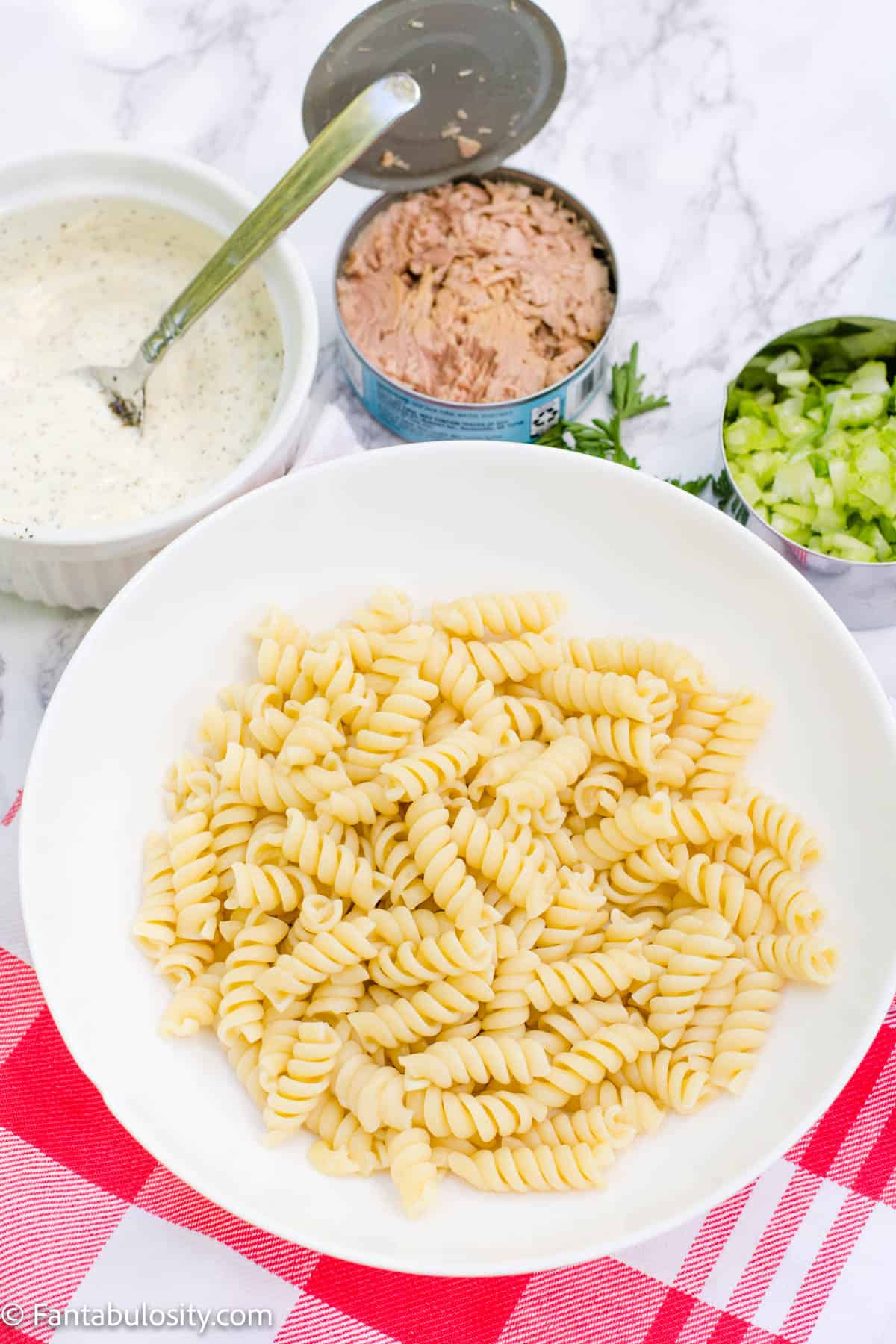 Cooked rotini in white bowl