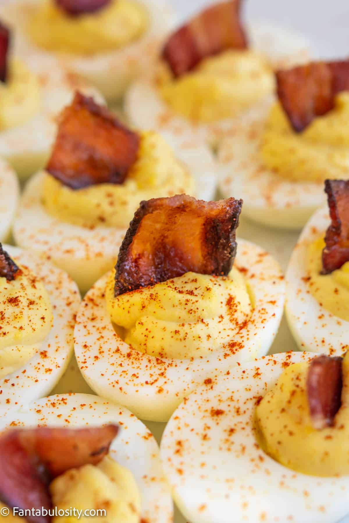 Close up of deviled eggs with bacon pieces
