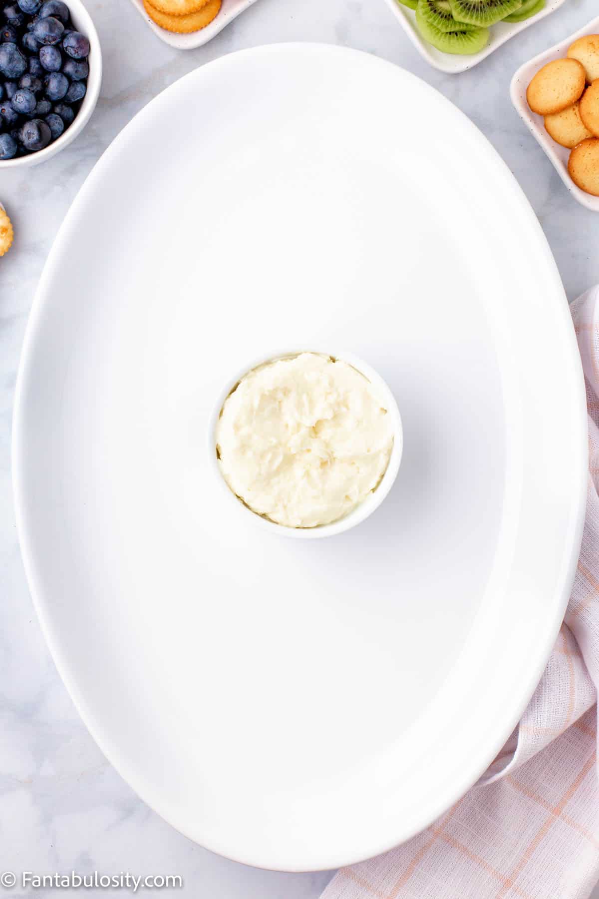 bowl of dip in white platter