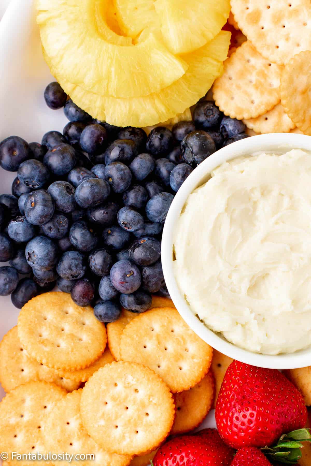 close up of blueberries, crackers and dip