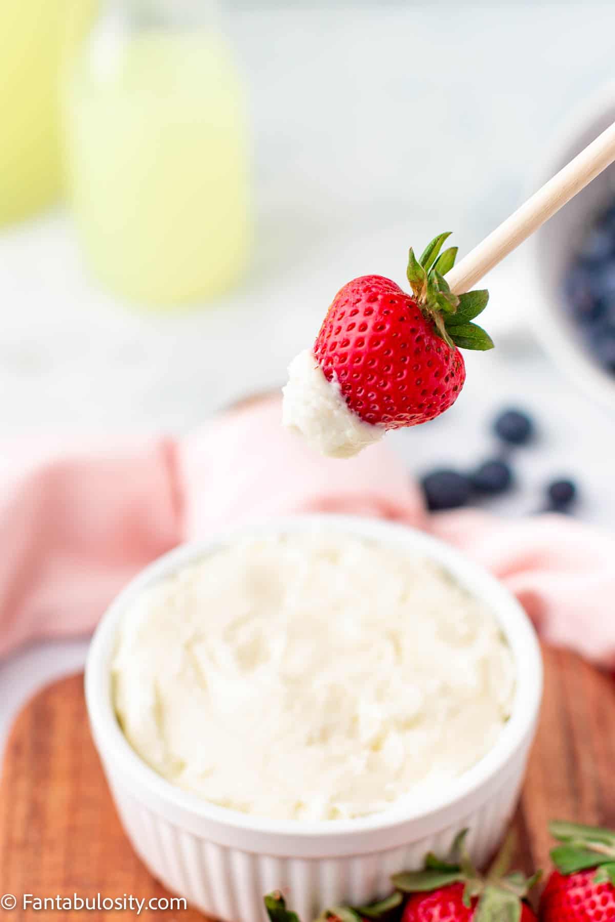 Strawberry dipping in to fruit dip