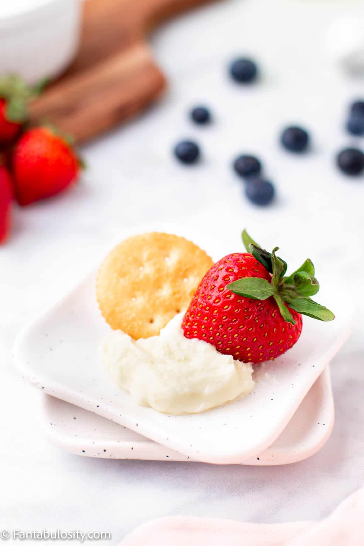 fruit and cracker with dip on plate