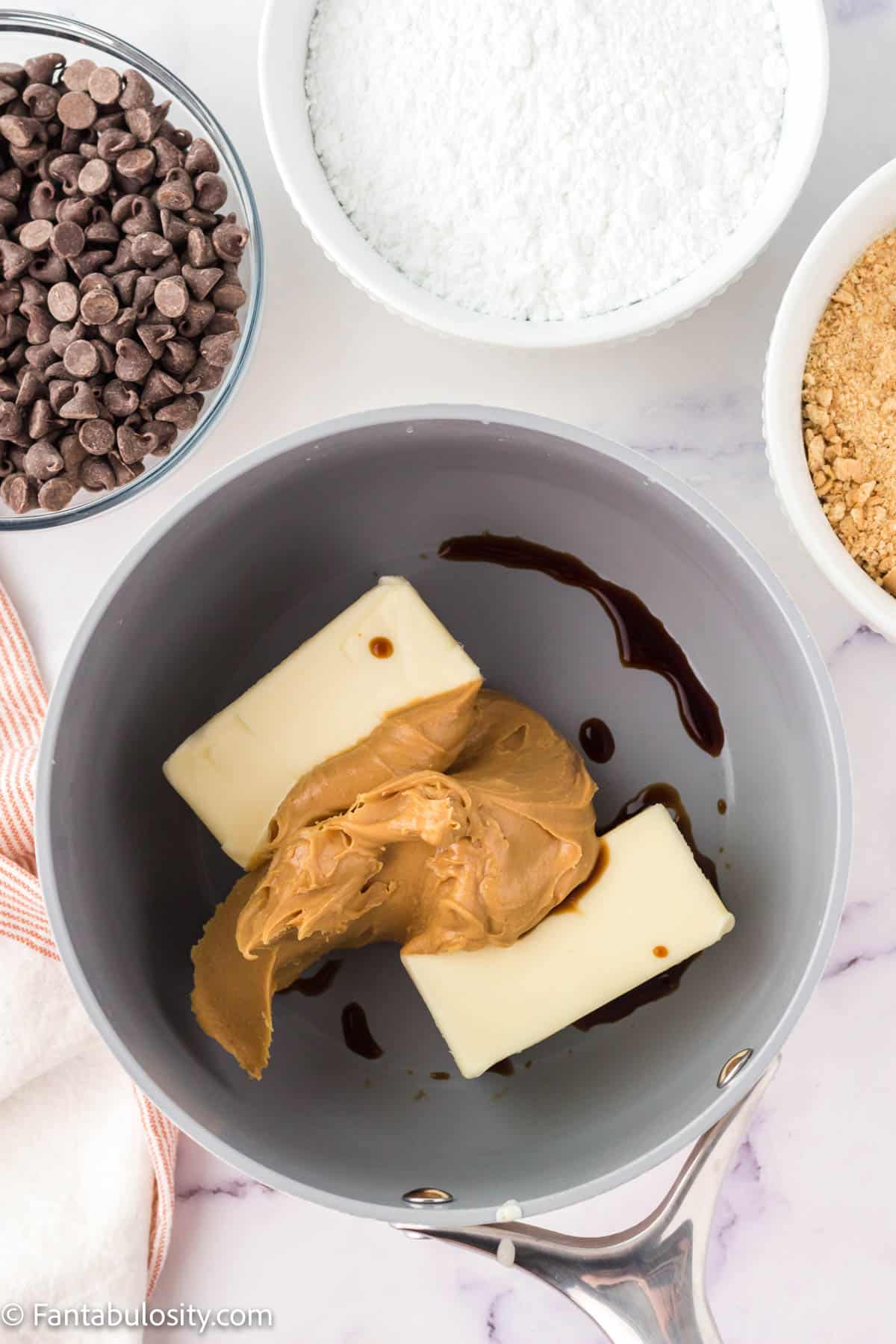 Peanut butter, butter, and vanilla in a saucepan. 