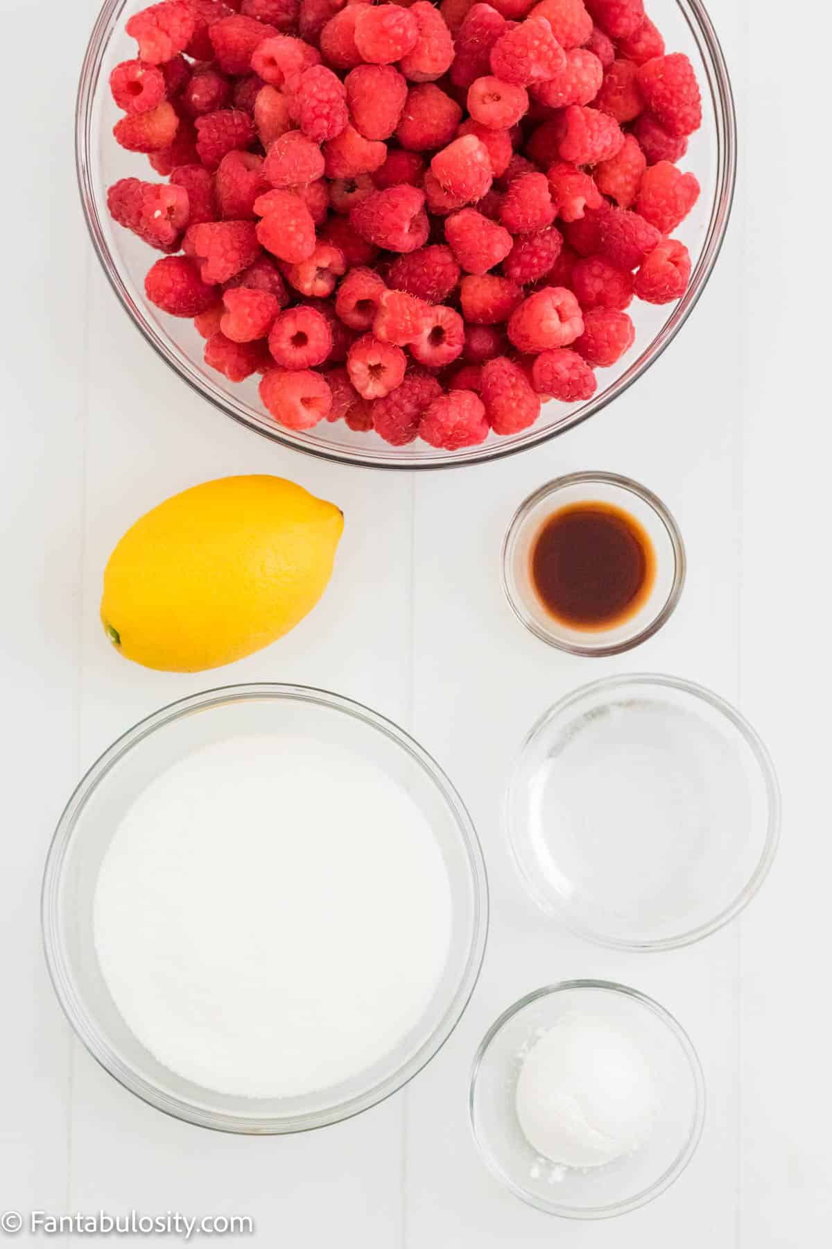 Photo of the ingredients for Instant Pot Raspberry jam including raspberries, lemons, sugar, water, cornstarch and vanilla extract