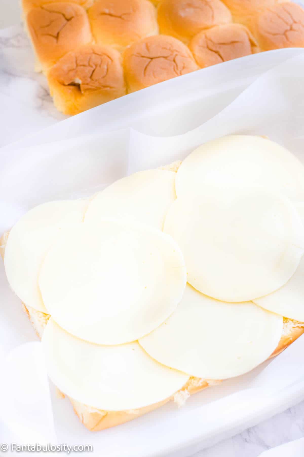 provolone cheese layered on hawaiian buns