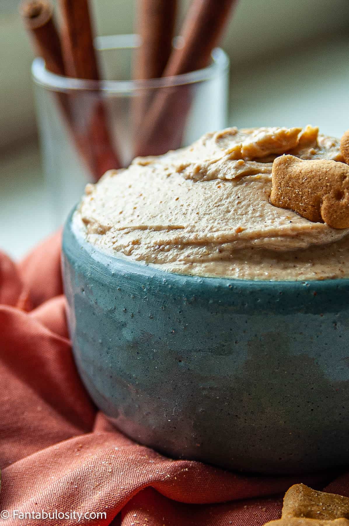 Close up photo of creamy Peanut Butter Yogurt Dip in a blue serving bowl with graham crackers for dipping