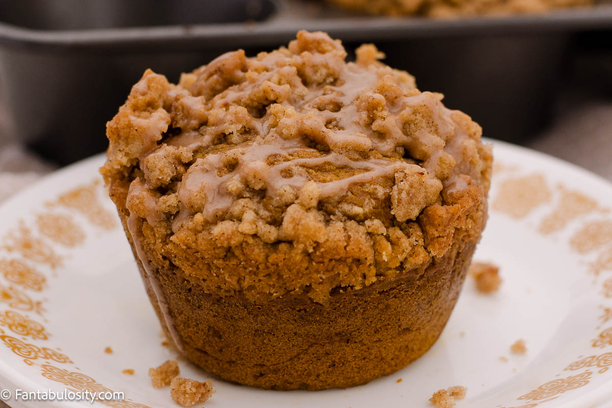 Jumbo pumpkin muffin with streusel topping on vintage plate. 